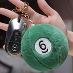 Billiard Ball Plush Set green number 6 pendant attached to a car keyring and held in a hand.