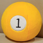 Billiard Ball Plush Set yellow number 1 ball resting on a beige seat.