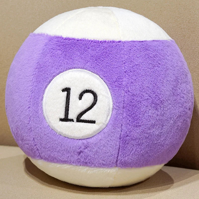 Billiard Ball Plush Set purple striped number 12 ball resting on a beige seat.