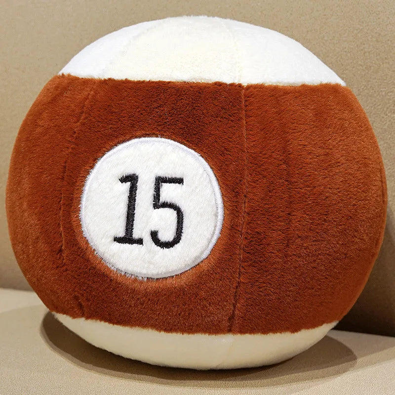 Billiard Ball Plush Set brown striped number 15 ball resting on a beige seat.