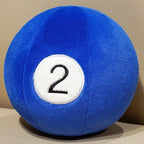 Billiard Ball Plush Set blue number 2 ball resting on a beige seat.