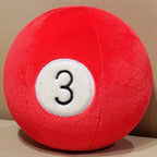 Billiard Ball Plush Set red number 3 ball resting on a beige seat.