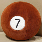 Billiard Ball Plush Set brown number 7 ball resting on a beige seat.