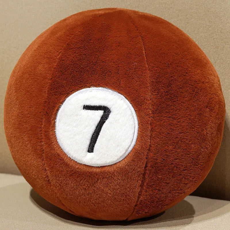 Billiard Ball Plush Set brown number 7 ball resting on a beige seat.