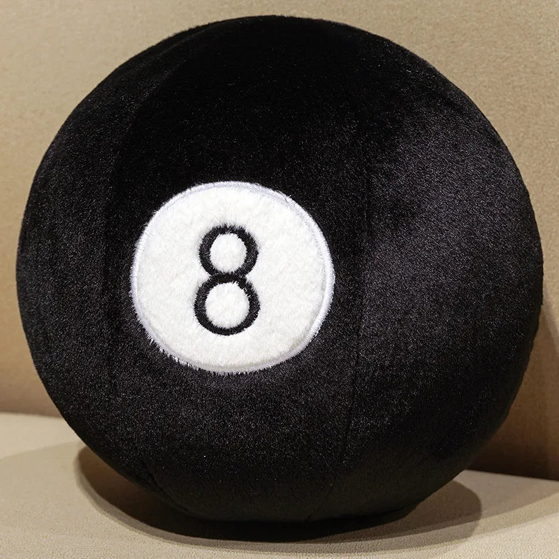 Billiard Ball Plush Set black number 8 ball resting on a beige seat.