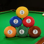 Billiard Ball Plush Set solid balls 1, 2, 3, 5, 6, and 7 stacked on a green pool table.