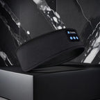 Black Bluetooth Sleep Headband with front controls in a modern dark marble product display