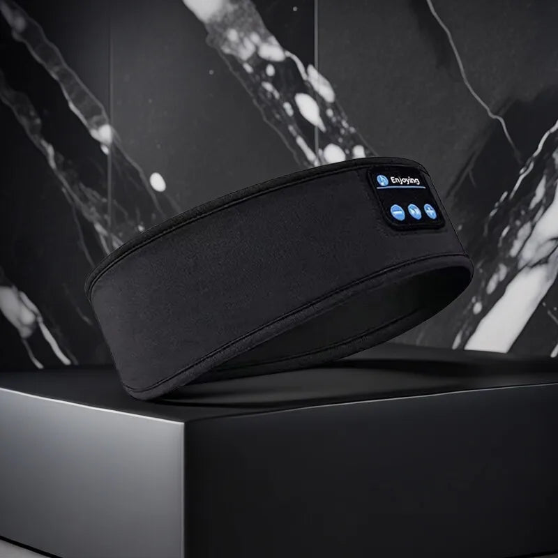 Black Bluetooth Sleep Headband with front controls in a modern dark marble product display