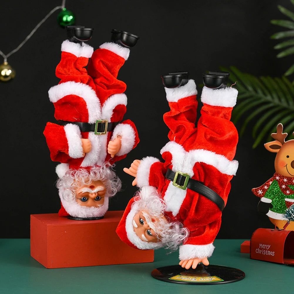 Breakdancing Santa Toy in Handstand and Headstand styles beside Christmas decorations.