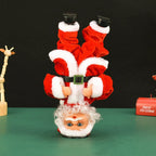 Breakdancing Santa Toy Headstand style displayed upside down beside a Merry Christmas decoration.