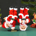Breakdancing Santa Toy two styles side by side on a green tabletop with festive ornaments.