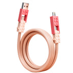 Building Block Charging Cable in pink, arranged in a coil with both connector ends angled outward