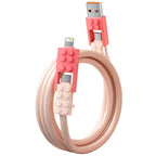 Building Block Charging Cable in pink with coral block-style adapters and coiled cable