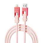 Building Block Charging Cable with upright pink connector housings, USB-A and Lightning adapters, and USB-C tips
