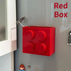 Building Block Storage Bins — Red bin holding a metal kitchen utensil on a gray refrigerator.
