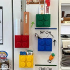 Building Block Storage Bins — Four colors holding kitchen wrap, utensils and packets on a decorated refrigerator.