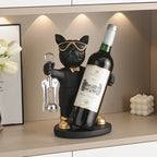 Bulldog Wine Bottle Holder black stand style holding a wine bottle beside a framed print and white decor.