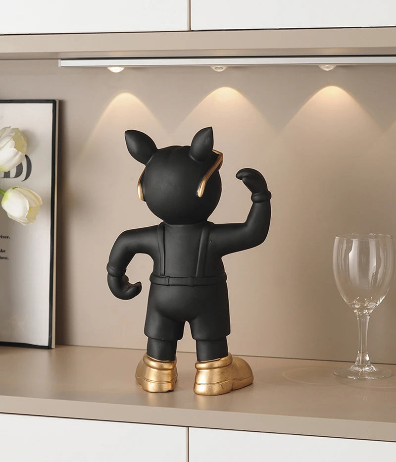 Bulldog Wine Bottle Holder black glass-style figurine from behind beneath cabinet lighting beside a wine glass.