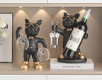 Bulldog Wine Bottle Holder black glass and bottle styles displayed together with the bottle holder on a book.