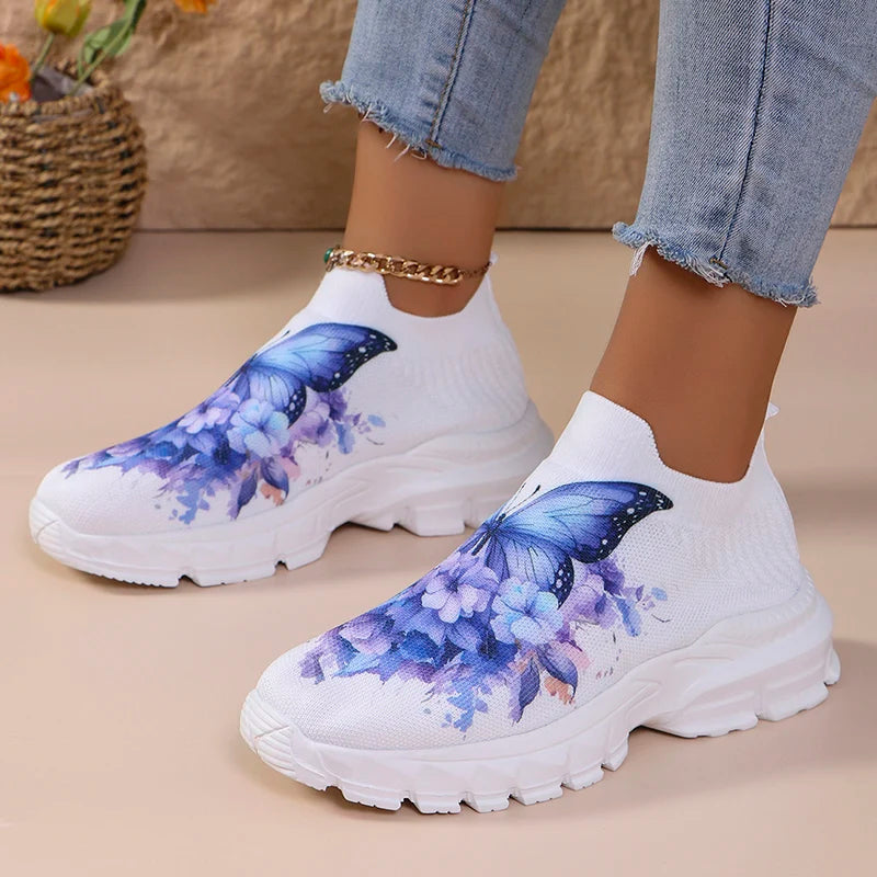 Butterfly Knit Shoes Blue Butterfly pair worn with light jeans, showing both low-top profiles on a beige floor.