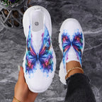 Butterfly Knit Shoes Colorful Butterfly shoe held beside a worn shoe, showing the insole and multicolor wing print.