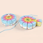 Cake Slice Favor Boxes in blue with coordinating ribbon and one box pulled from the round display