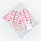 Cake Slice Favor Boxes in pink shown unassembled with foldable paperboard pieces and ribbon