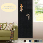 Cat Scratching Wall Mat black variant displayed vertically beside a sofa and window