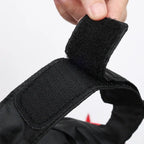 Centipede Pet Costume close-up showing the adjustable black hook-and-loop fastening being opened by hand.