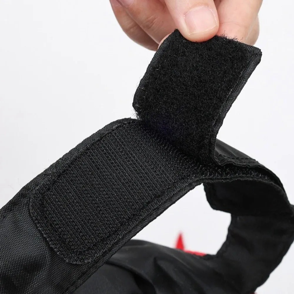 Centipede Pet Costume close-up showing the adjustable black hook-and-loop fastening being opened by hand.