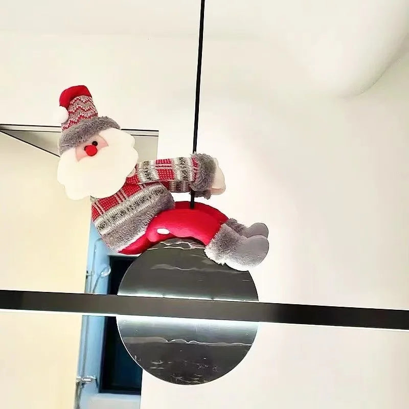 Christmas Chandelier Hugger Santa character wrapped around a black pendant light cord