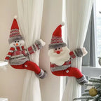 Christmas Chandelier Hugger Santa and snowman characters decorating white curtains by a Christmas tree