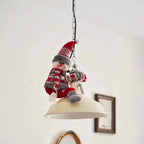 Christmas Chandelier Hugger snowman character seated on a chain-hung pendant lamp