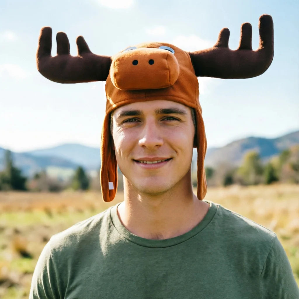 Christmas Moose Hat close-up on an adult outdoors, with plush brown antlers and hanging side flaps.