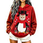Model wearing a red penguin Christmas pet carrier hoodie with a cat's head visible through the pouch opening.