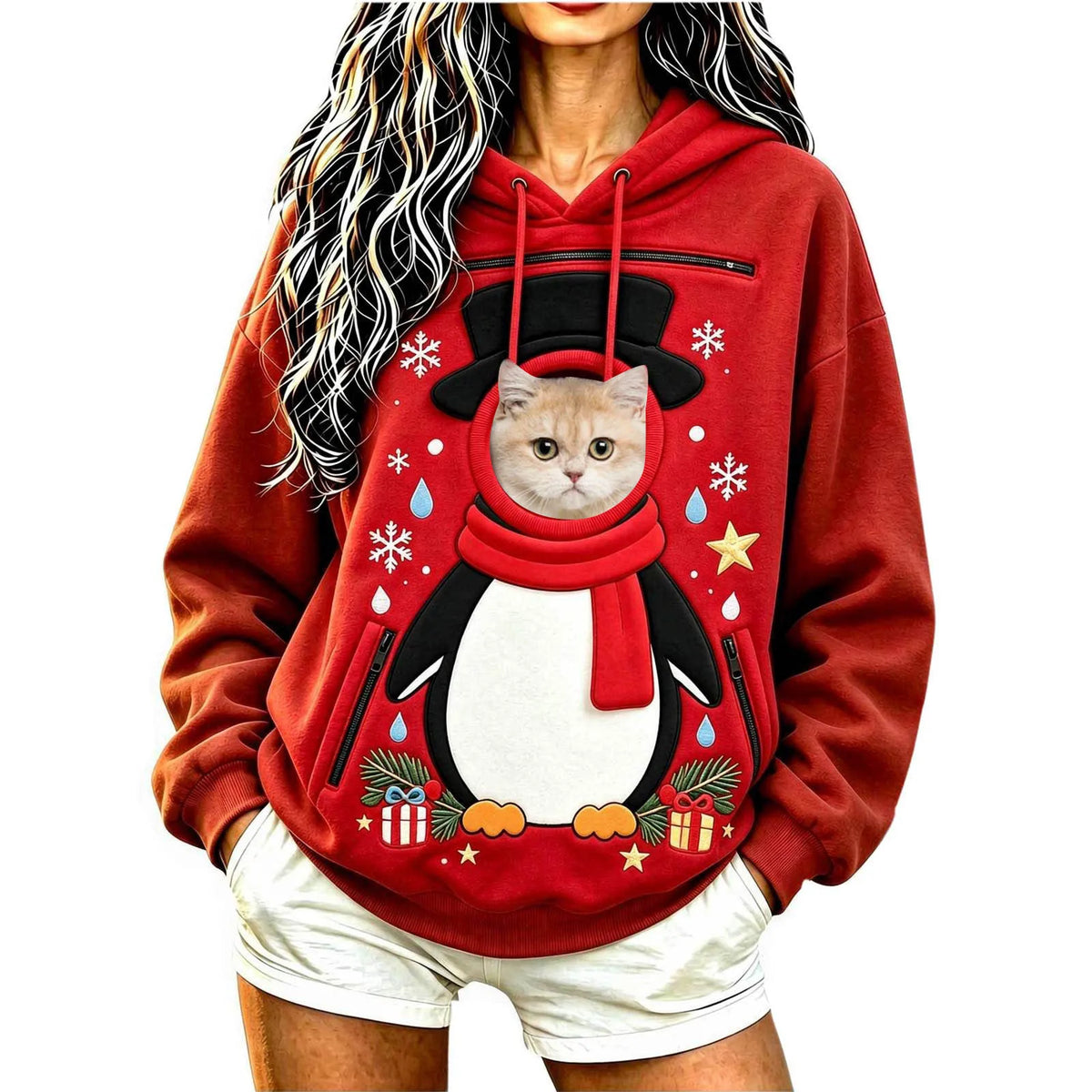 Model wearing a red penguin Christmas pet carrier hoodie with a cat's head visible through the pouch opening.