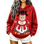 Cat peeking out of a red snowman Christmas pet pouch hoodie worn by a model.
