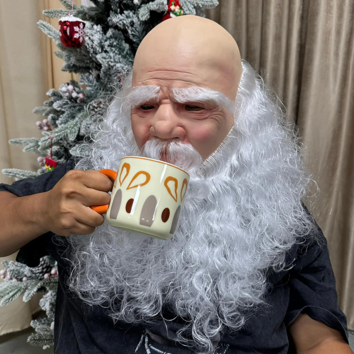 Christmas Santa Mask worn without a hat while holding a patterned mug near the white moustache.