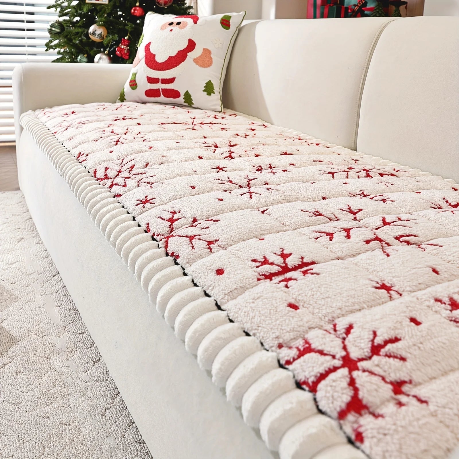 Christmas Sofa Pad Cover in creamy white with red snowflake embroidery arranged across a living room sofa
