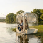 Clear View Bubble Tent beside a lake with two seated anglers and rods extending toward the water.
