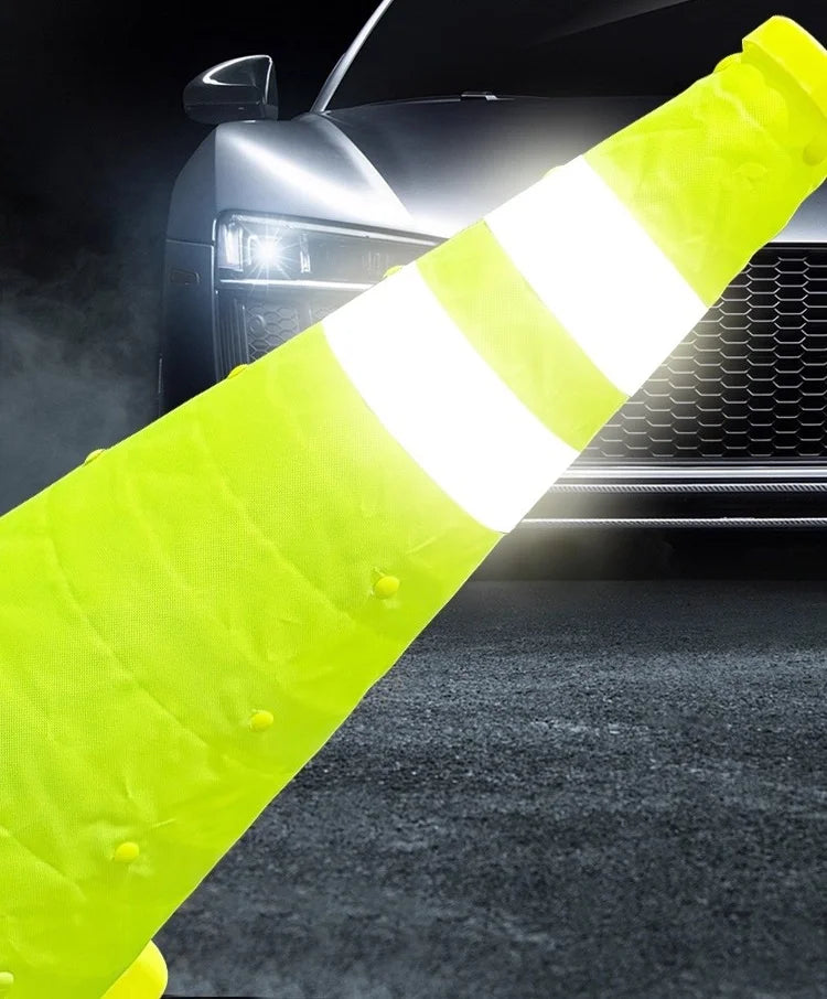 Collapsible Reflective Safety Cone fabric body as vehicle headlights illuminate its gray reflective bands