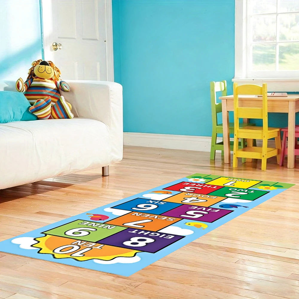 Colorful numbered hopscotch mat on a wooden playroom floor beside a white sofa and children's table.