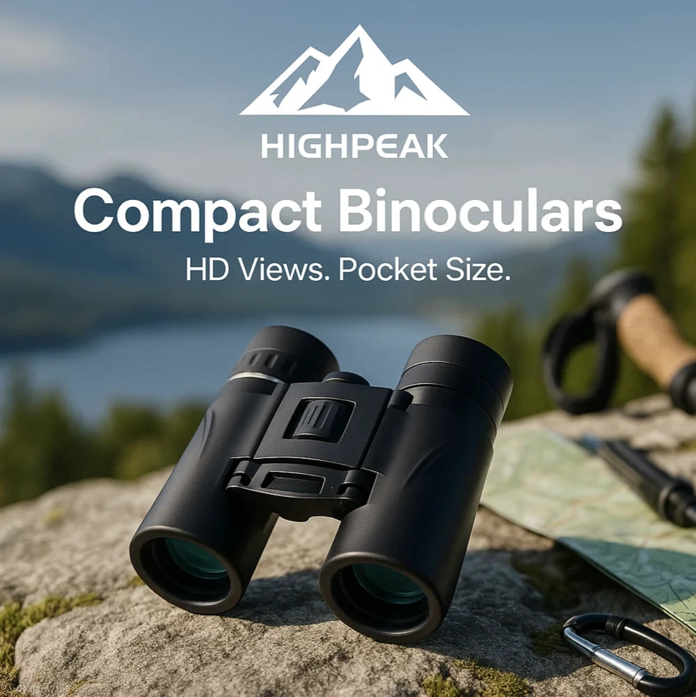 HighPeak Compact Binoculars in black on a rock with outdoor gear and scenic mountain background for hiking use