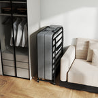 Compact Foldaway Guest Bed stored upright between a wardrobe and sofa in a small living space.