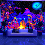 Cosmic Bonfire UV Tapestry displayed behind a white sofa, showing the bonfire scene and blue eye motif.