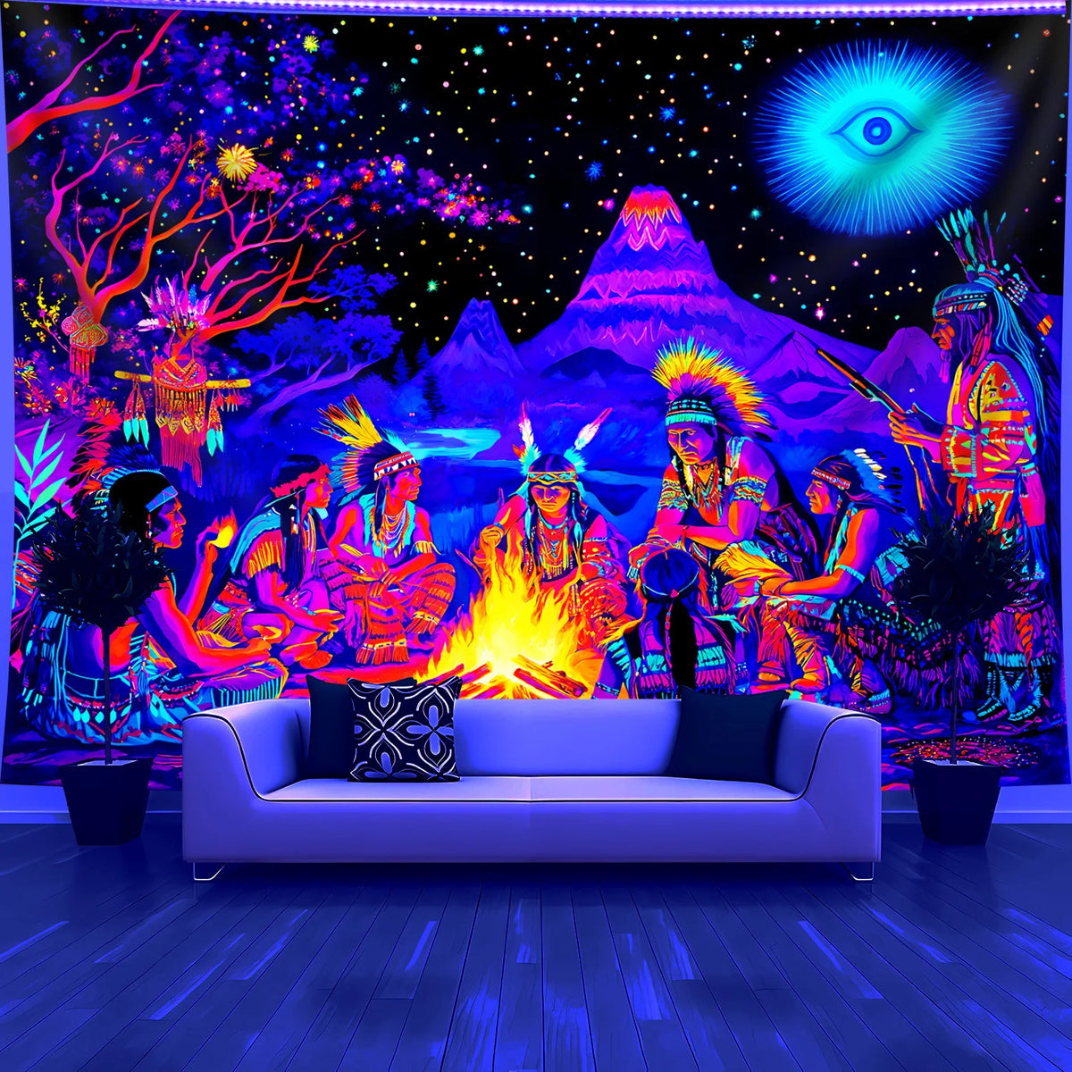 Cosmic Bonfire UV Tapestry displayed behind a white sofa, showing the bonfire scene and blue eye motif.