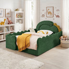 Green full-size dinosaur bed with padded side rails and yellow throw in a children’s bedroom