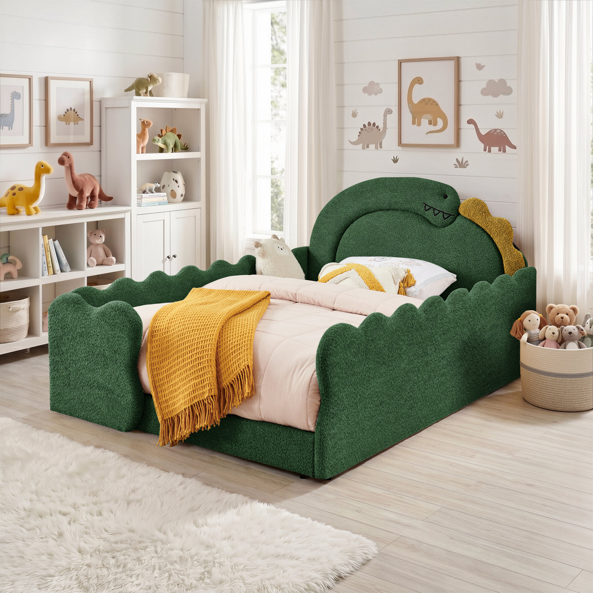 Green full-size dinosaur bed with padded side rails and yellow throw in a children’s bedroom