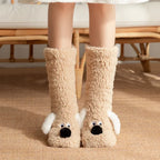 Cozy Dog Ear Socks in a light beige shade, worn on a woven rug with white ears and black noses