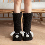 Cozy Dog Ear Socks in black, with contrasting white ears and noses, shown from the front